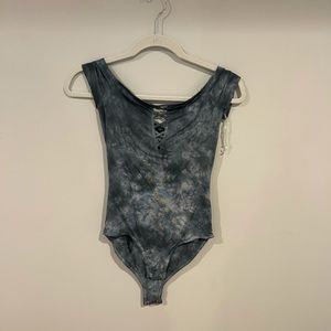 Never worn tie dye blue body suit with crosses on front